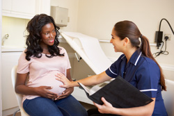 Pregnant Woman speaking with a Nurse