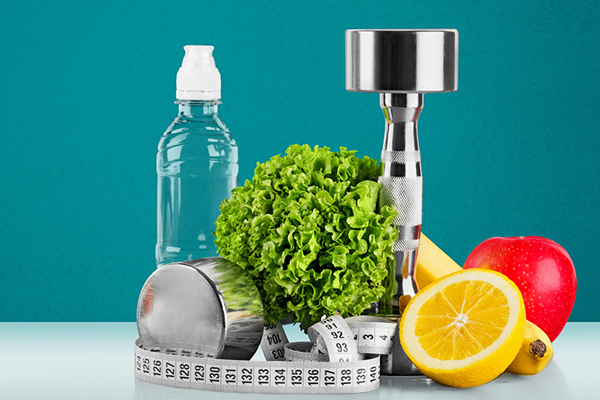 an assortment of health items such as a water bottle, weights, and healthy foods