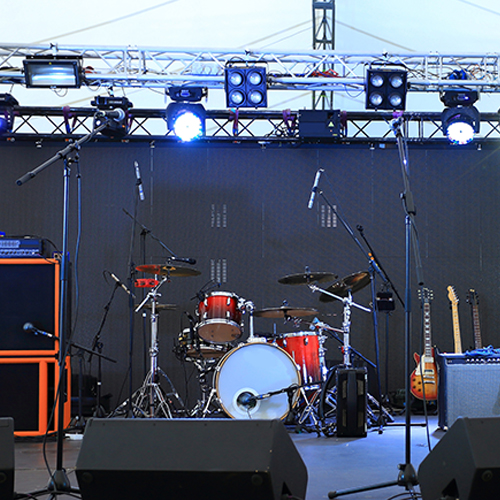 a stage with a set of drums and some guitars